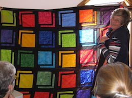 Liz Hendrickson displaying her latest quilt